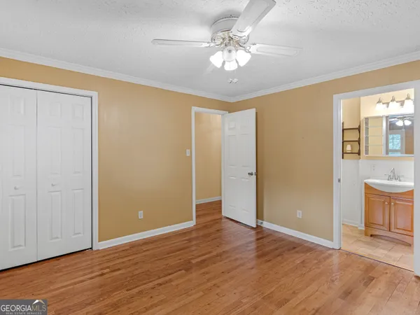 a view of an empty room with wooden floor