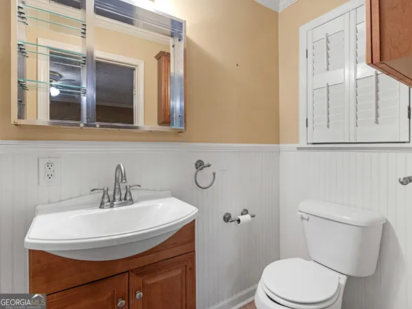 a bathroom with a sink a mirror and a toilet