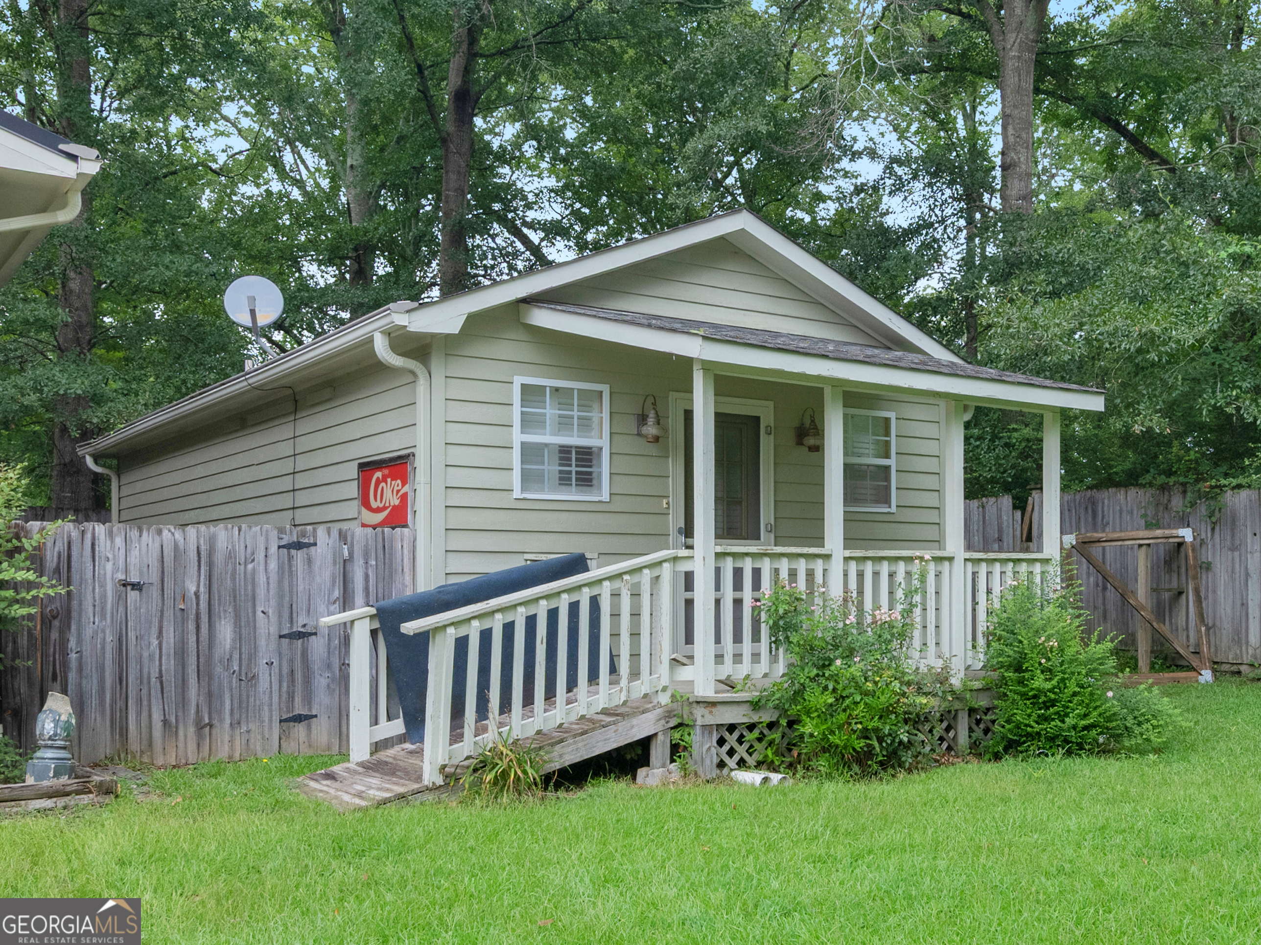 105 Zebulon Street Milner, GA 30257 - Photo 26 of 34 a front view of a house with garden