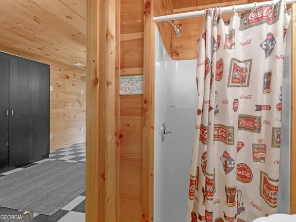 a bathroom with a shower and a sink