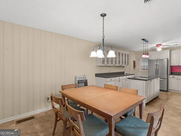 a view of a dining room with furniture and chandelier