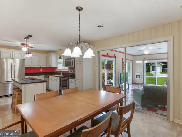 a view of a dining room with furniture wooden floor and chandelier