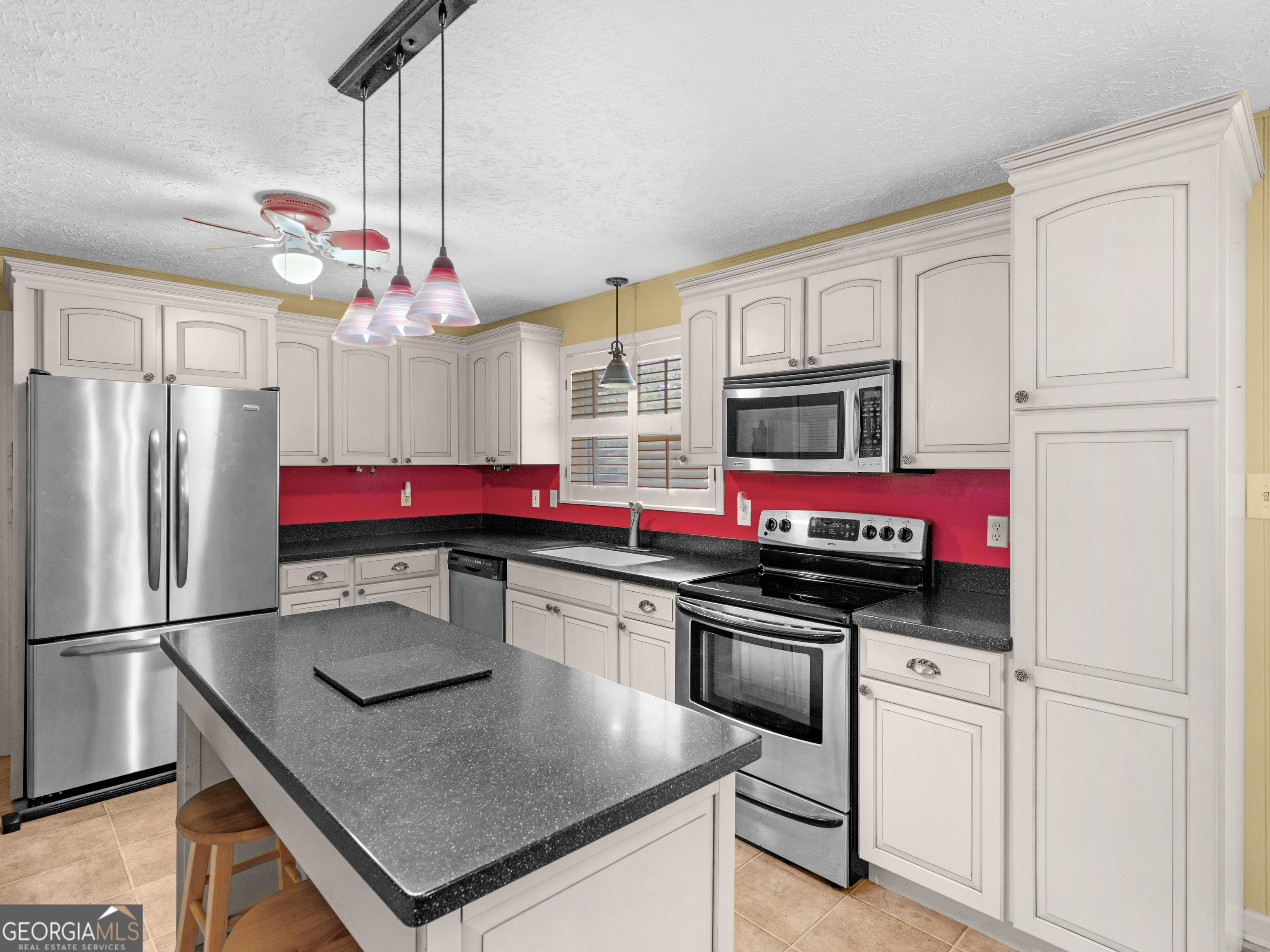 105 Zebulon Street Milner, GA 30257 - Photo 8 of 34 a kitchen with stainless steel appliances a sink stove and refrigerator