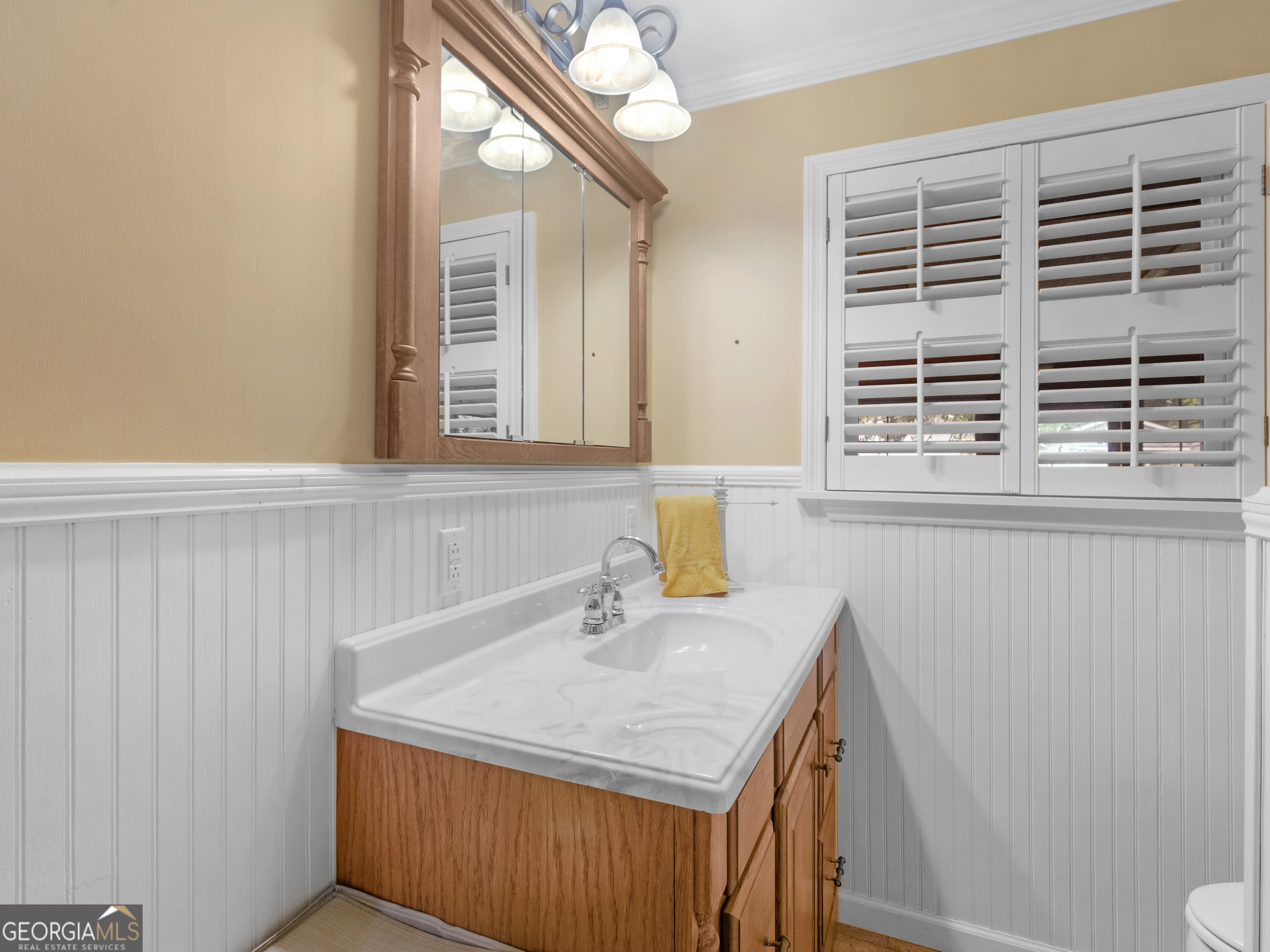 105 Zebulon Street Milner, GA 30257 - Photo 10 of 34 a bathroom with a sink a vanity and a window