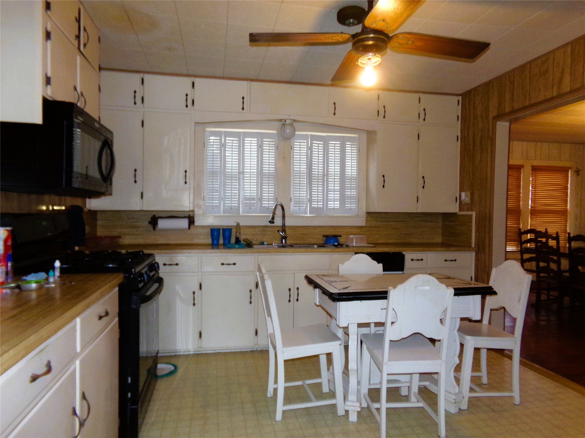 403 North West Street Weimar, TX 78962 - Photo 2 of 16 a kitchen with a table chairs microwave and cabinets