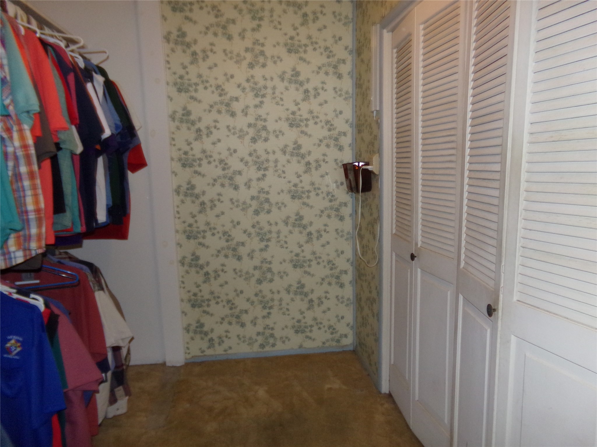 403 North West Street Weimar, TX 78962 - Photo 7 of 16 a view of walk in closet with clothes and shoes