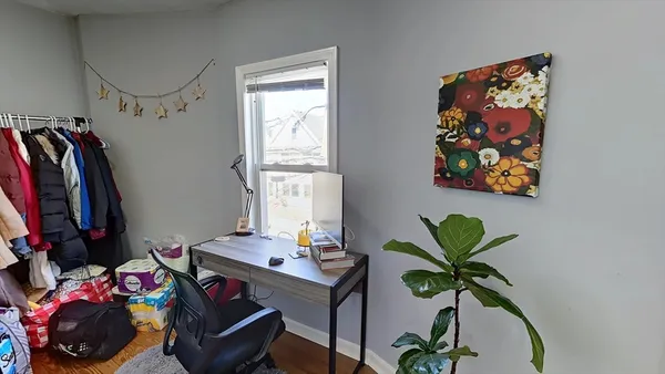 a view of a workspace with furniture and a potted plant