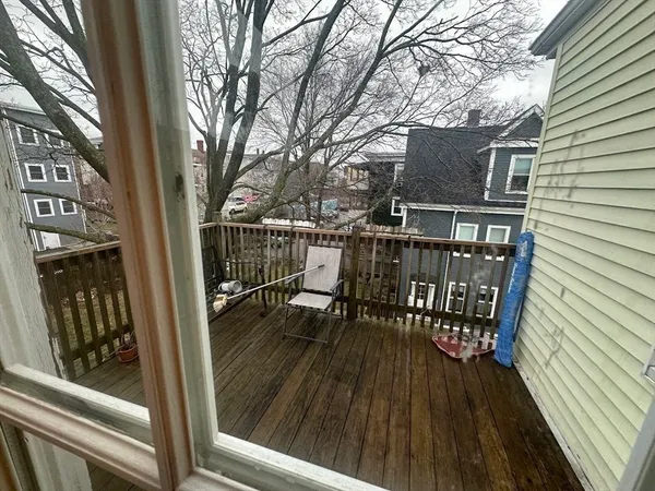 a view of balcony with wooden floor and seating space