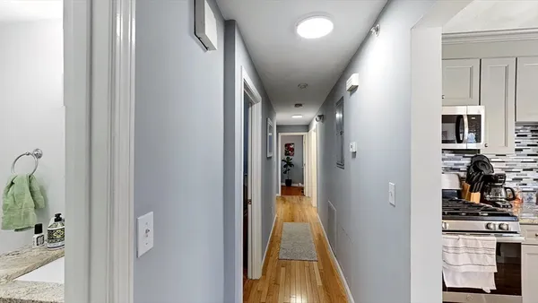 a view of hallway with living room and furniture