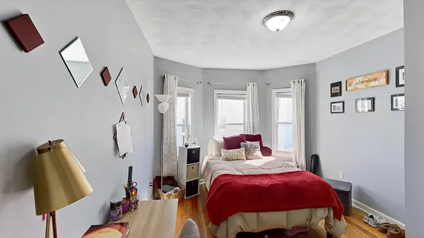 a bedroom with a bed and a lamp