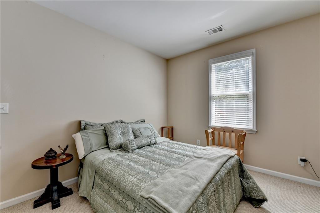 6415 Hampton Rock Lane Cumming, GA 30041 - Photo 14 of 26 a bedroom with a bed and a window