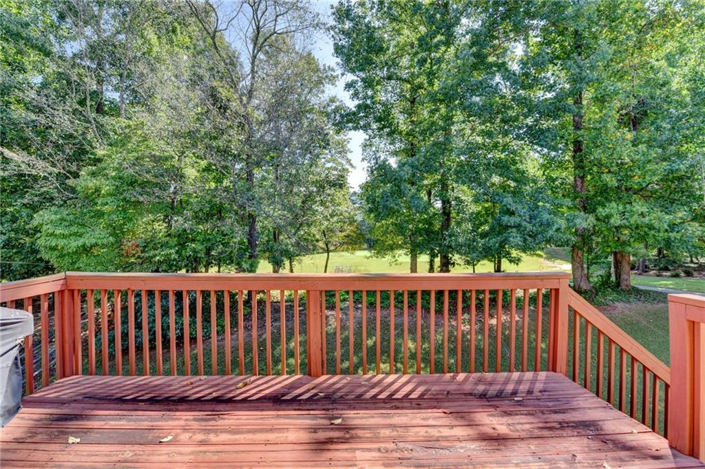 6415 Hampton Rock Lane Cumming, GA 30041 - Photo 16 of 26 a view of a wooden roof deck