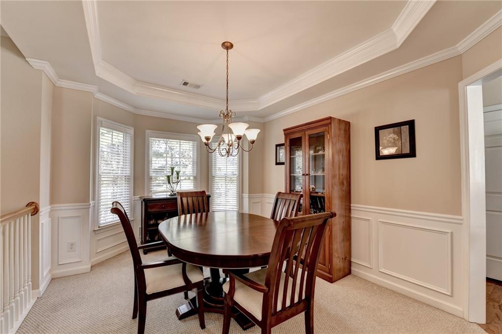 6415 Hampton Rock Lane Cumming, GA 30041 - Photo 3 of 26 a view of a dining room with furniture window and wooden floor