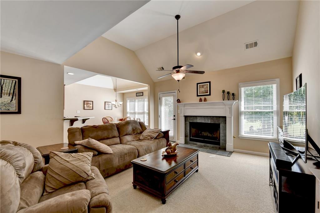 6415 Hampton Rock Lane Cumming, GA 30041 - Photo 4 of 26 a living room with furniture and a fireplace