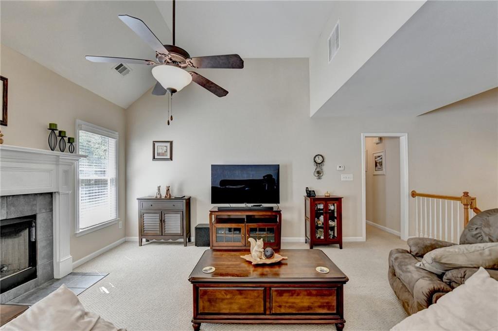 6415 Hampton Rock Lane Cumming, GA 30041 - Photo 5 of 26 a living room with furniture and a flat screen tv