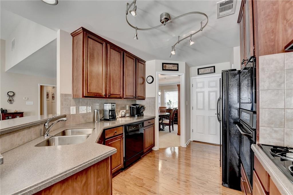 6415 Hampton Rock Lane Cumming, GA 30041 - Photo 6 of 26 a kitchen with stainless steel appliances granite countertop a sink refrigerator and cabinets