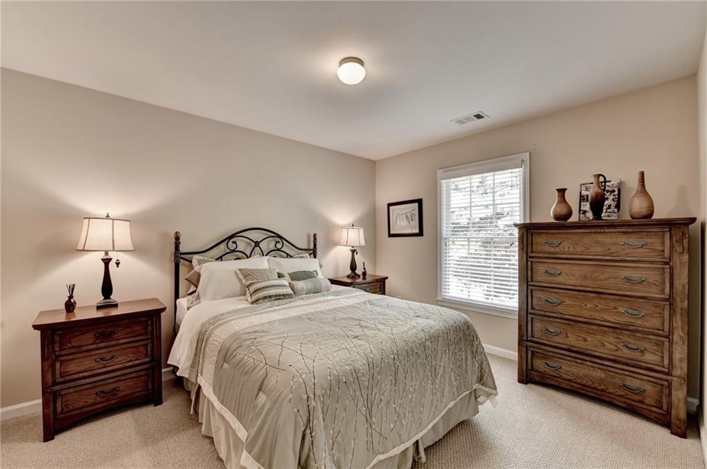 6415 Hampton Rock Lane Cumming, GA 30041 - Photo 10 of 26 a bedroom with a bed and a dresser