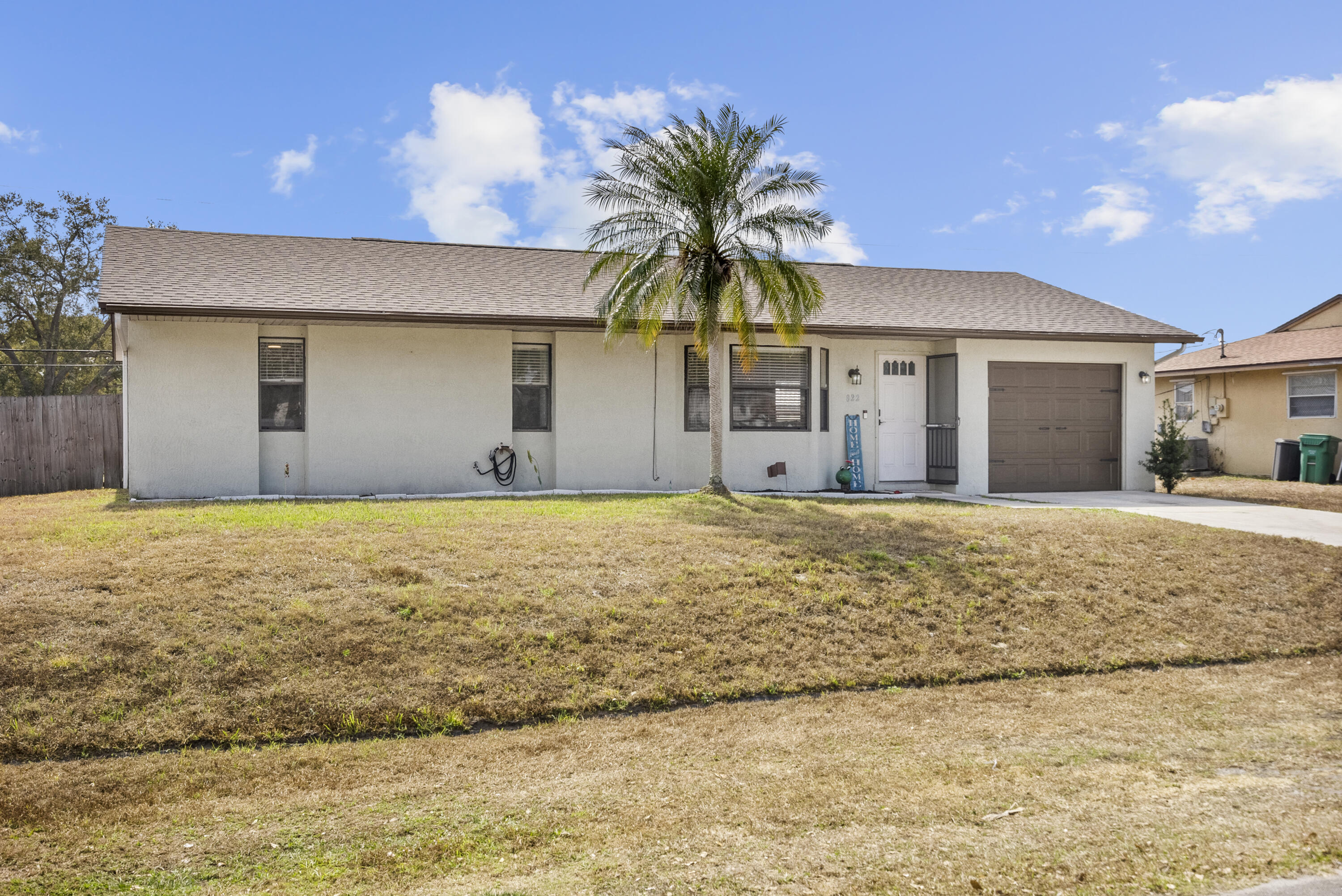 822 Southwest Harvard Road Port St. Lucie, FL 34953 - Photo 2 of 43 a view of a house with a yard