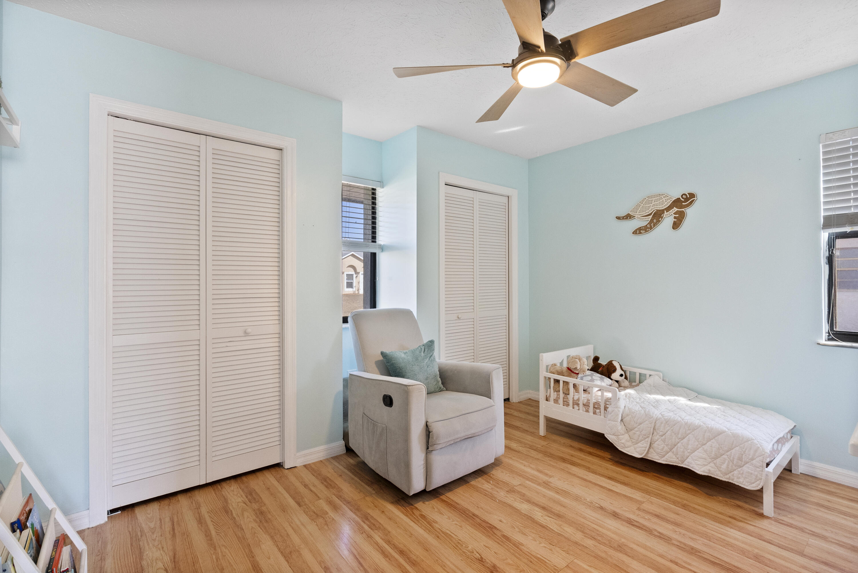 822 Southwest Harvard Road Port St. Lucie, FL 34953 - Photo 23 of 43 a bedroom with furniture and wooden floor