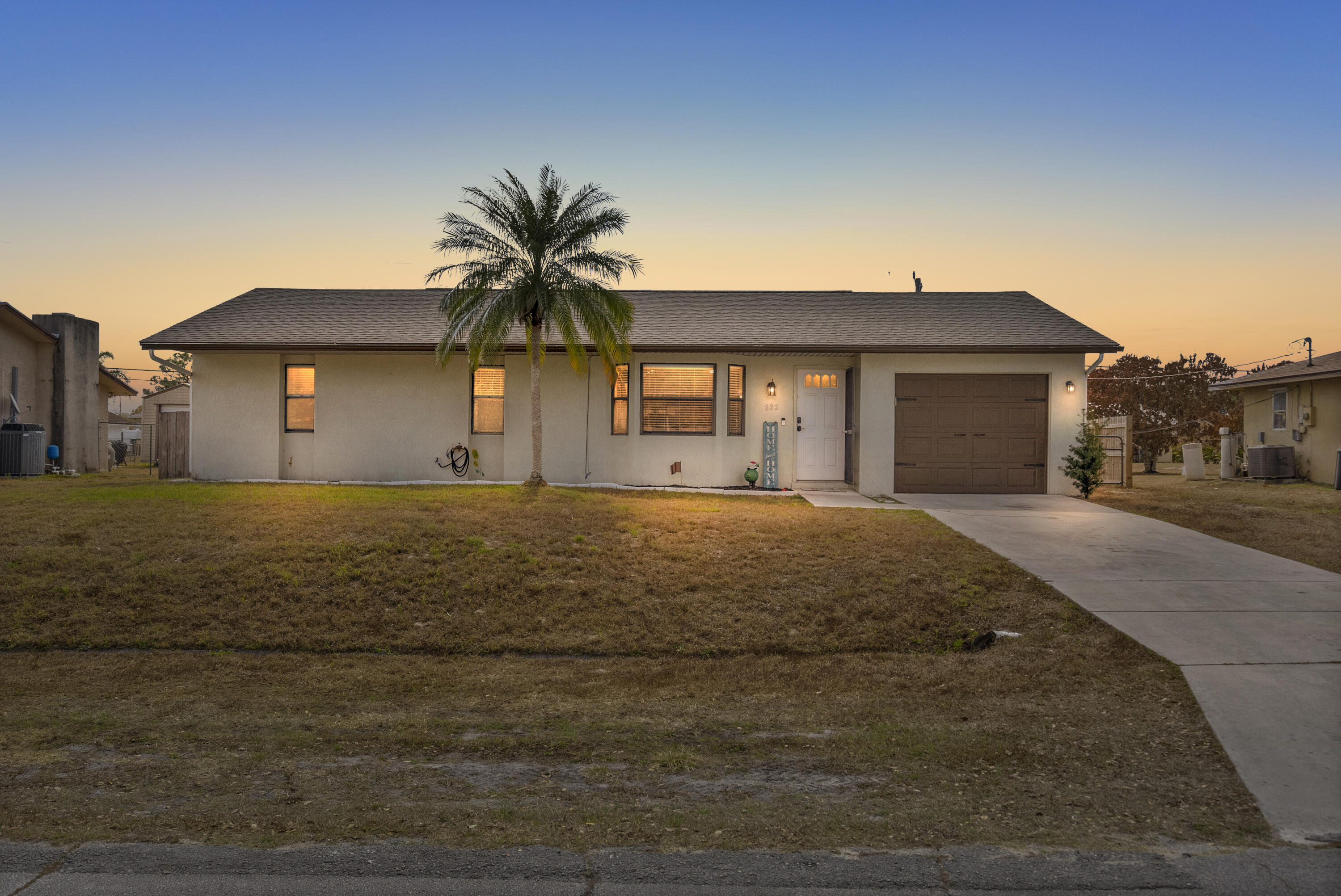 822 Southwest Harvard Road Port St. Lucie, FL 34953 - Photo 37 of 43 a front view of a house with a yard