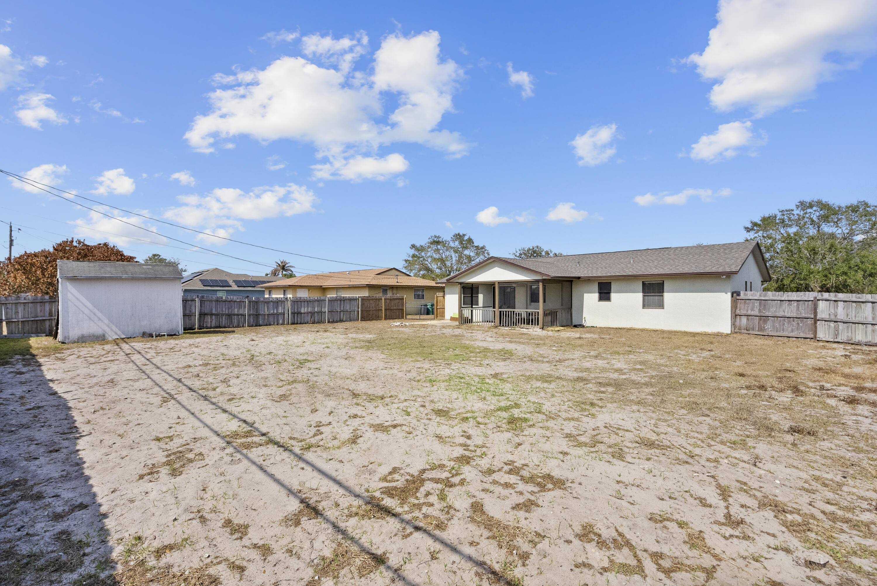 822 Southwest Harvard Road Port St. Lucie, FL 34953 - Photo 42 of 43 a front view of a house with a yard