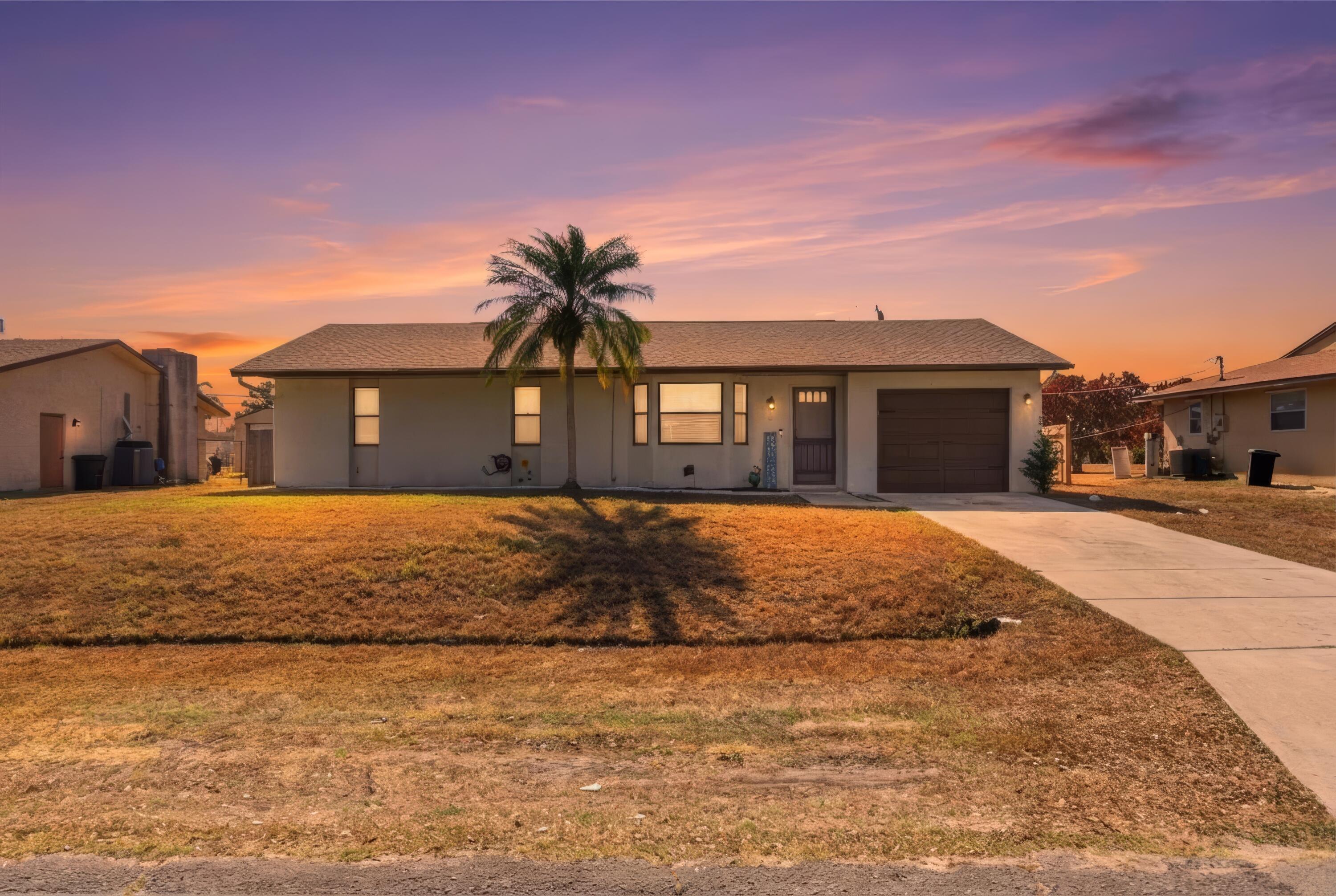822 Southwest Harvard Road Port St. Lucie, FL 34953 - Photo 43 of 43 a front view of a house with a yard
