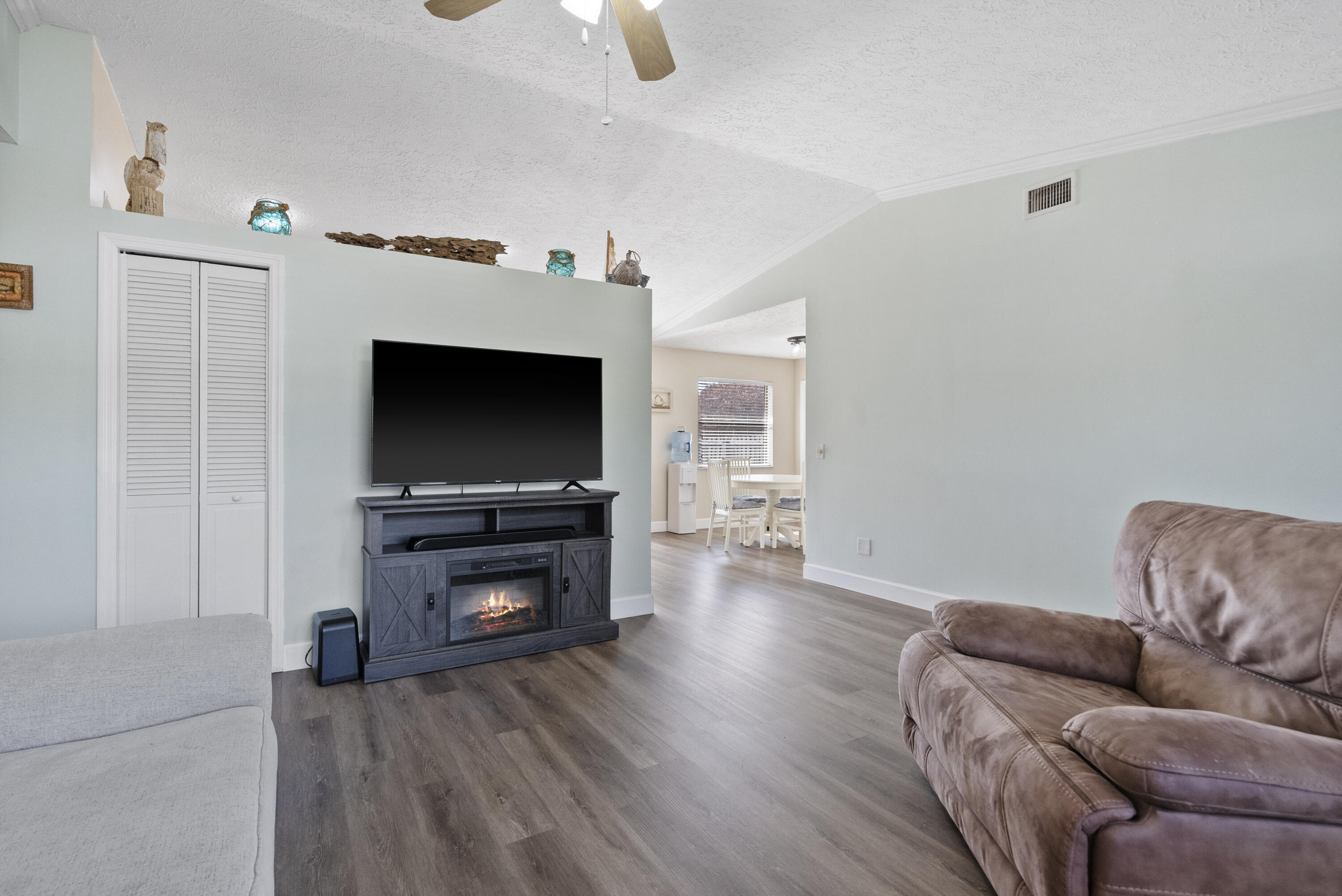 822 Southwest Harvard Road Port St. Lucie, FL 34953 - Photo 7 of 43 a living room with furniture and a flat screen tv
