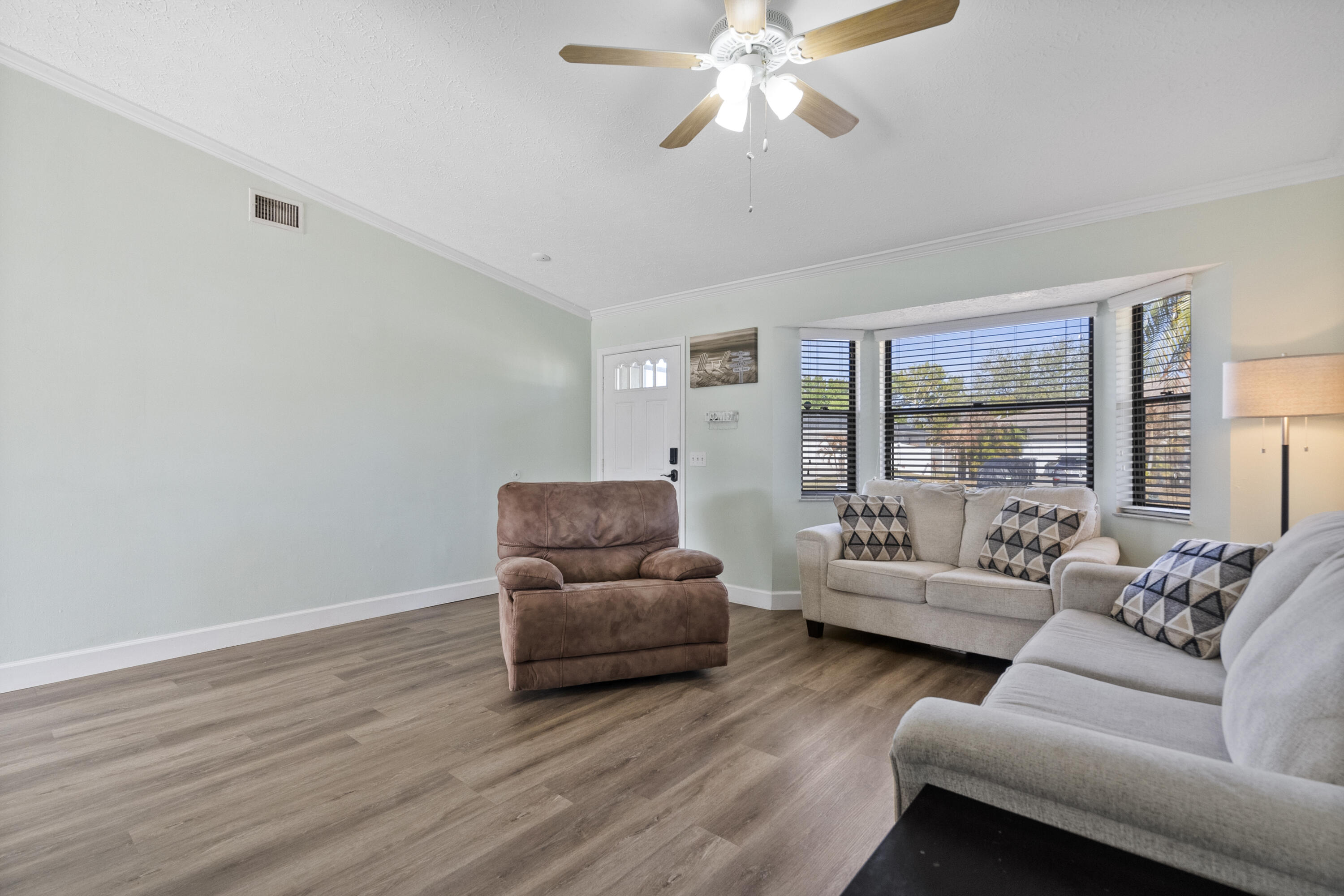 822 Southwest Harvard Road Port St. Lucie, FL 34953 - Photo 9 of 43 a living room with furniture and a large window