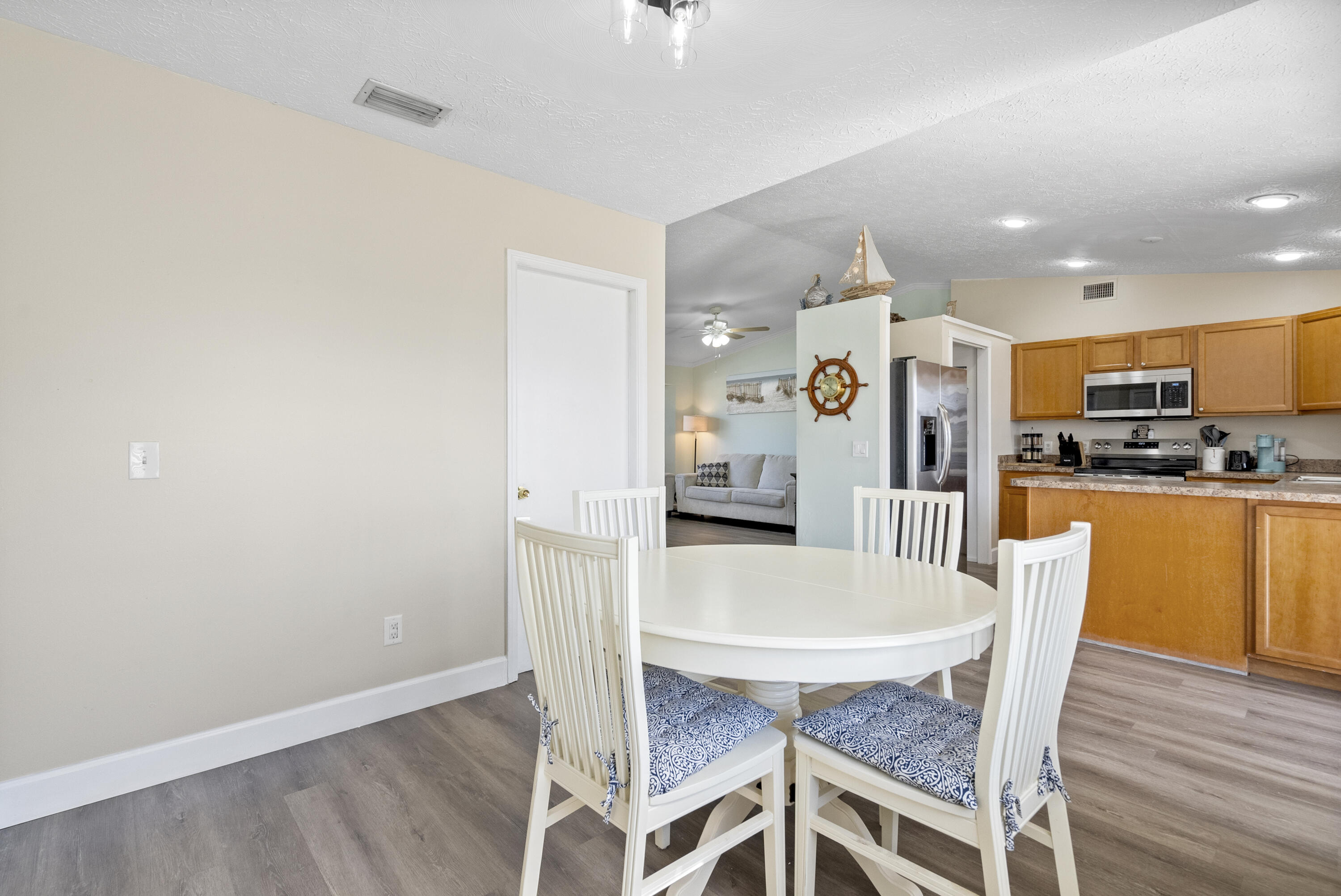 822 Southwest Harvard Road Port St. Lucie, FL 34953 - Photo 10 of 43 a view of a dining room with furniture and wooden floor