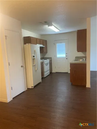 a view of kitchen with furniture and wooden floor