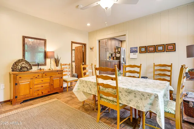 a living room with furniture a flat screen tv and a table