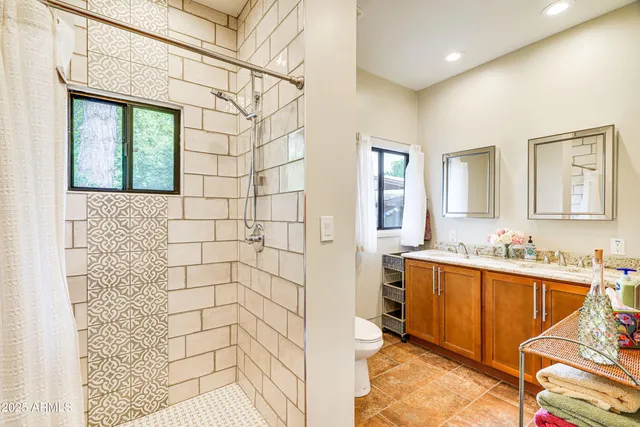 a bathroom with a sink a mirror and a shower