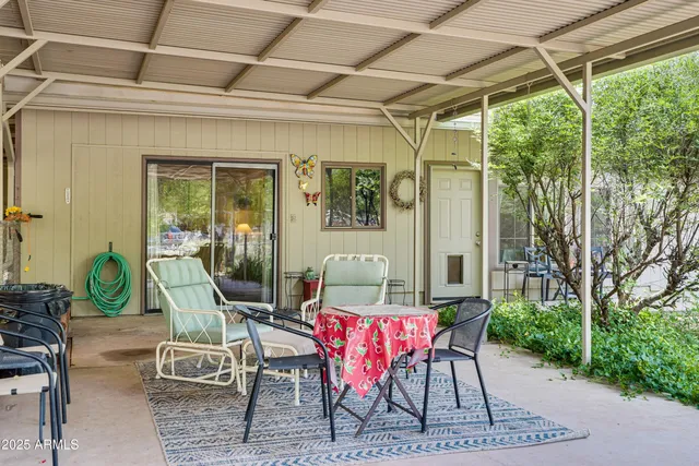 a view of outdoor dining space with a table and chairs