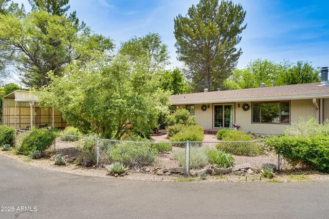 a front view of a house with a yard garage and outdoor seating