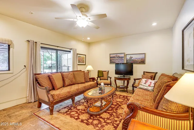 a living room with furniture and a large window