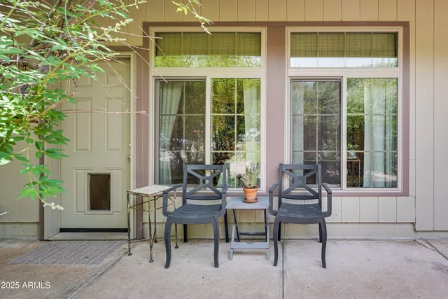 a balcony with furniture and a potted plant