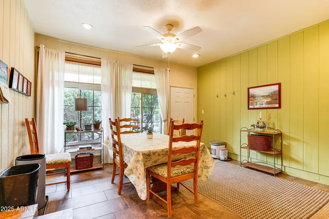 a living room with fireplace furniture and a large window