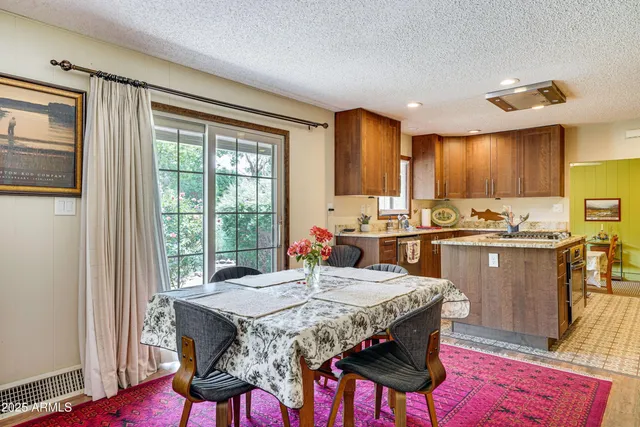 a kitchen with a table chairs sink and cabinets