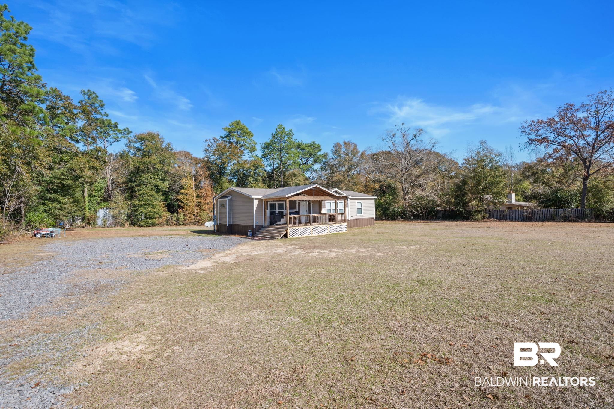 15080 Starlight Avenue Wilmer, AL 36587 - Photo 2 of 29 View of front facade with a porch and a front yard