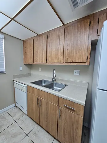 a kitchen with stainless steel appliances granite countertop a sink and dishwasher