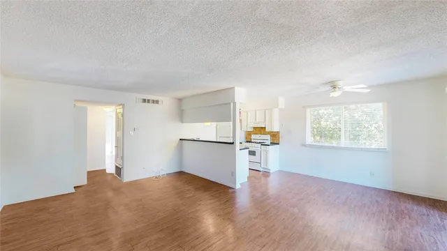 a view of a kitchen with a sink and a window