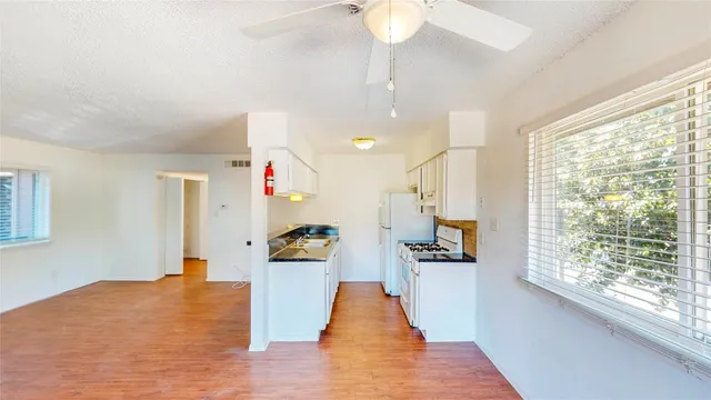 a view of a living room and kitchen with furniture