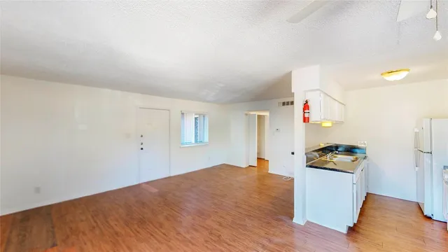 a kitchen with granite countertop a sink and a stove top oven