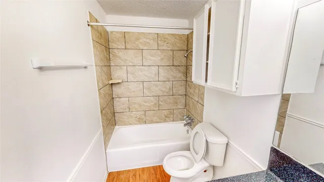 a bathroom with a sink a toilet and bathtub