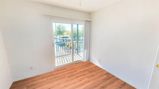a view of a room with wooden floor and a window