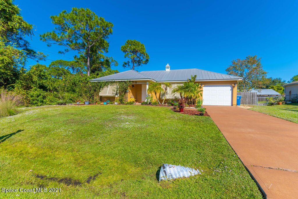 1063 Whitehurst Road Southwest Palm Bay, FL 32908 - Photo 3 of 20 a view of a white house with a yard