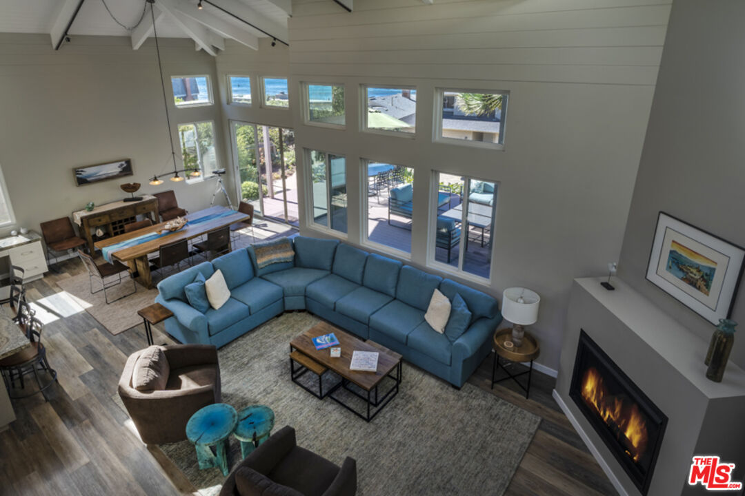 191 Rincon Point Road Carpinteria, CA 93013 - Photo 17 of 19 a living room with furniture fireplace and a flat tv screen