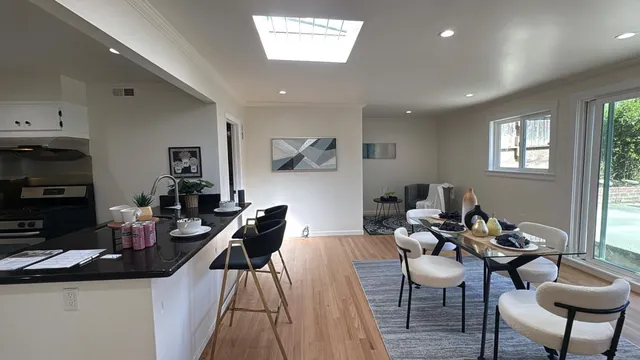 a dining room with furniture and a window