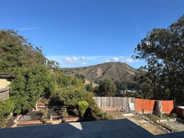 a view of city from balcony with seating space