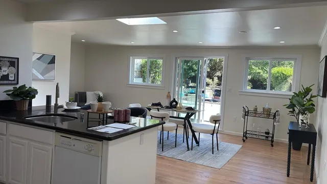 a kitchen with a table chairs stove and cabinets